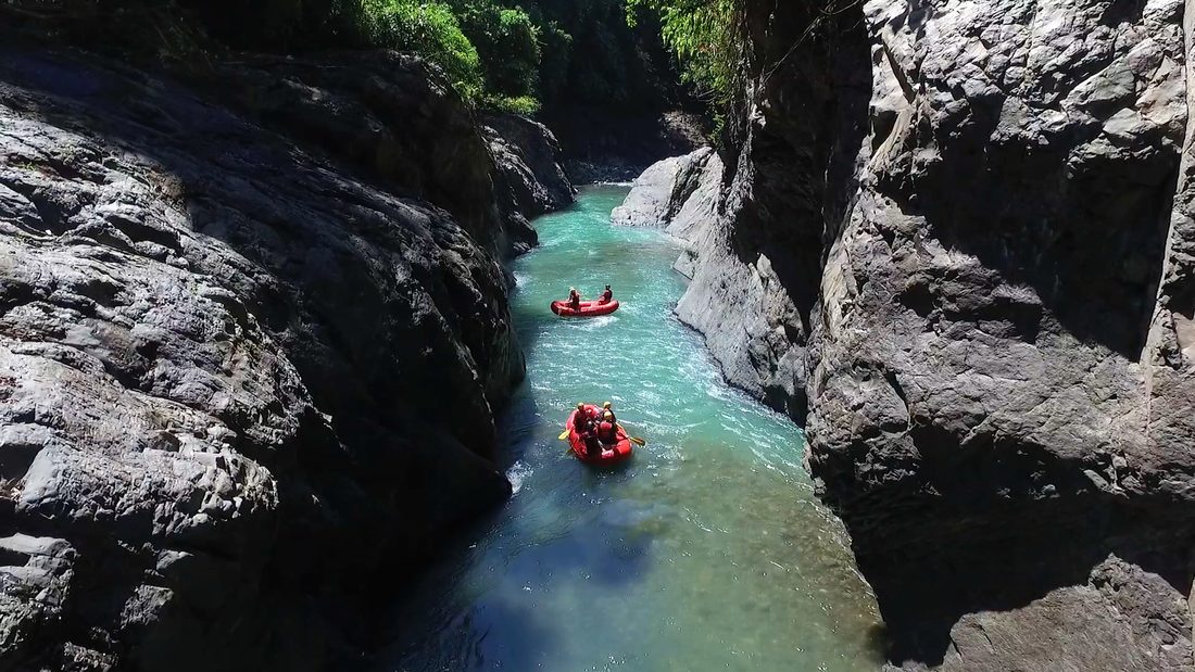 Two rafts on green water deep inside the Chorro gorge
