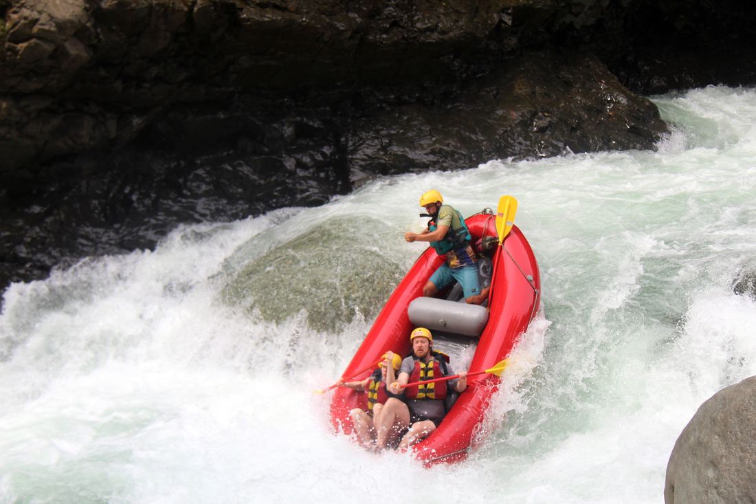 A raft going nose-first down a steep rapid on El Chorro