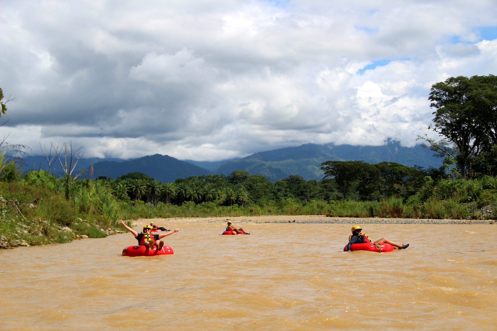 Guests spread out on the river under a cloudy sky