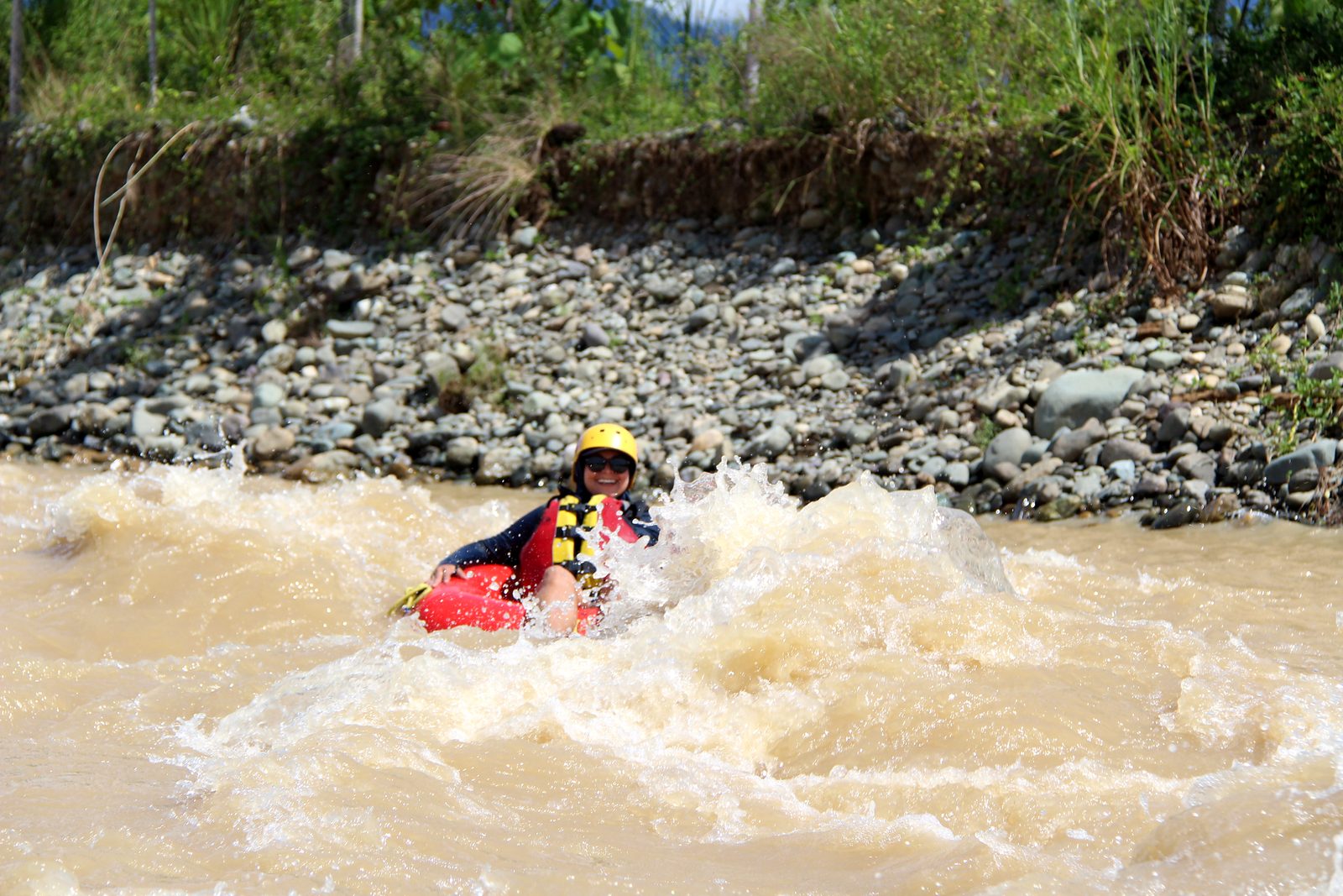 A guest rides a splashy wave in her tube