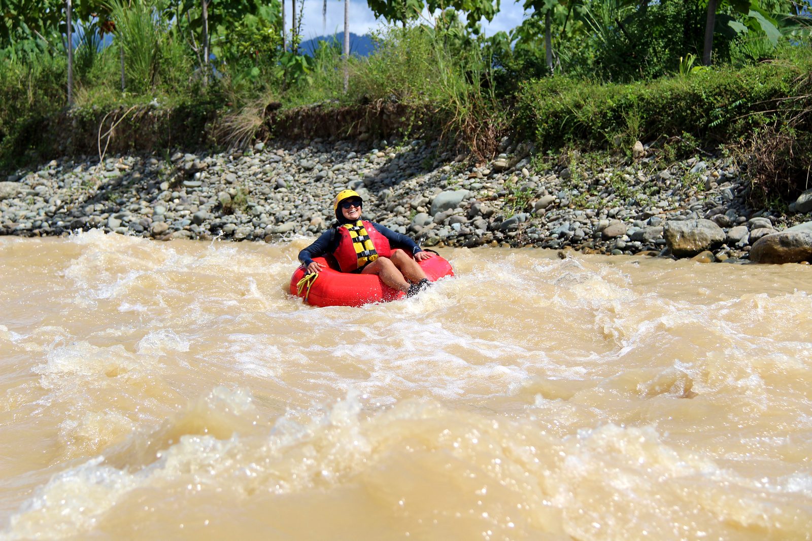 A guest bounces through white water in her tube